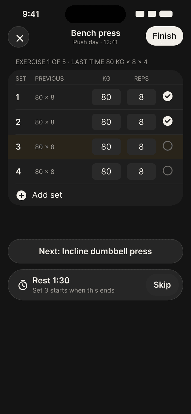 Bench press mid-workout on iPhone. Sets are on the phone, with a rest timer and the next exercise.